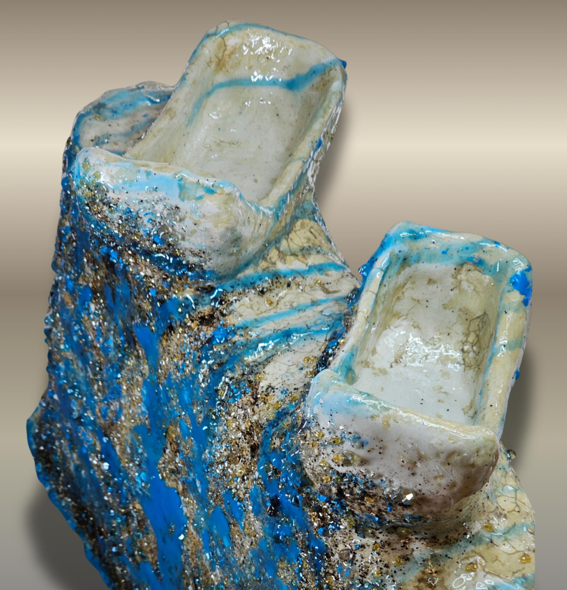 Modelled in clay, gauze, paper mâché and finished with glass beads, acrylic paint, and epoxy resin, the sculpture keeps sprinkles of eggshell to remember its origins and to mark new beginnings.